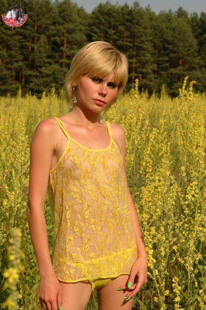 Young looking blonde girl shows her skinny body amid blooming wild flowers - #13