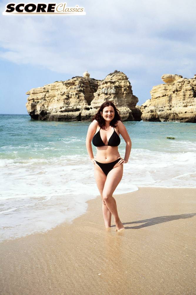 Brunette MILF Lorna Morgan releases her nice melons from bikini on a beach - #2