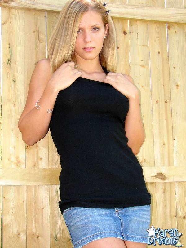 Young blond girl Karen shows her thigh gap during SFW upskirt action in a yard - #9