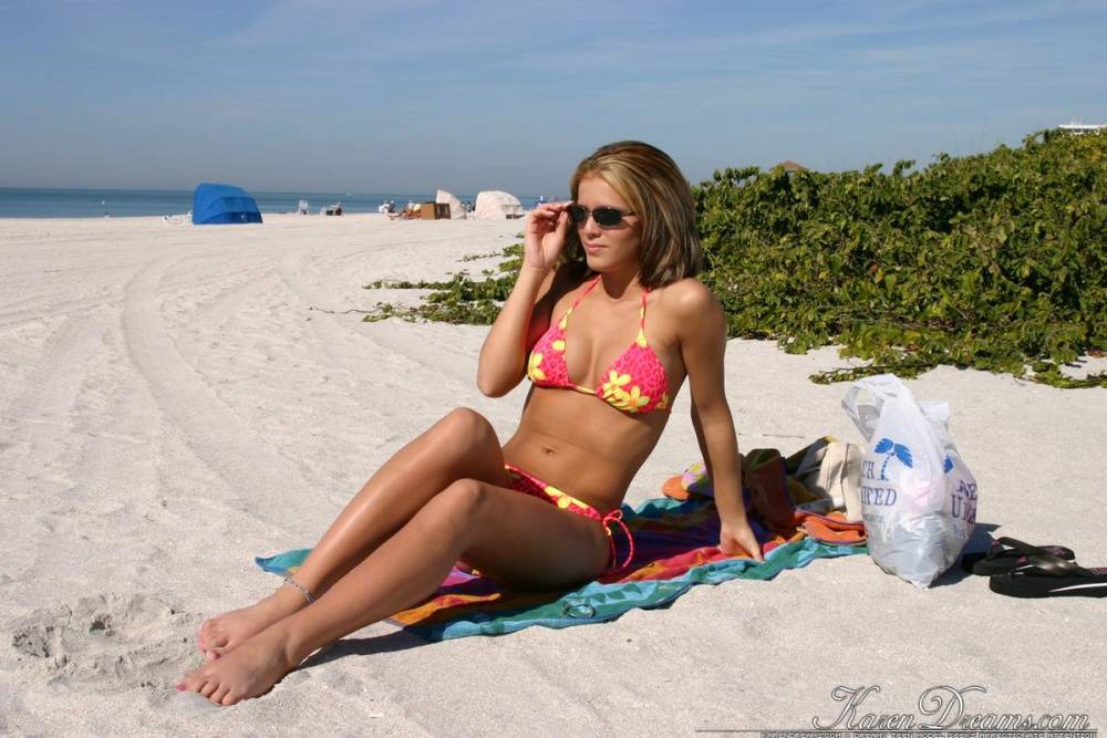 Teen solo girl Karen relaxes at the beach in a bikini and sunglasses - #11