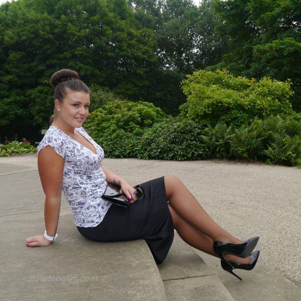 Clothed woman Karen displays her new stiletto heels at a park | Photo: 380669