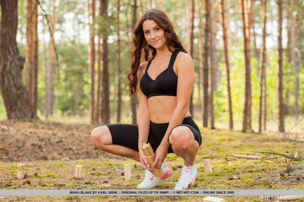 Sweet teen Mara Blake removes spandex attire on a yoga mat in a forest | Photo: 387116