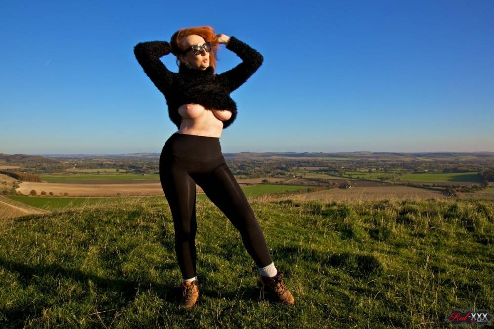 British woman with red hair uncovers her big boobs on a hill on a windy day - #8