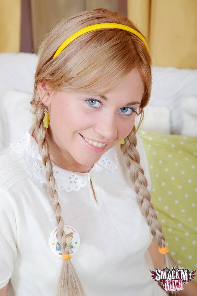 Lindsey sits on the bed in her schoolgirl outfit with her hair in braided - #6