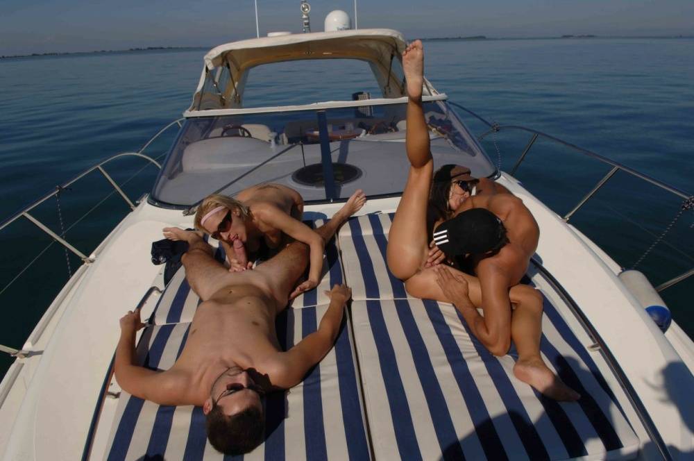 A bottle of downed wine leads to group sex action atop a boat at sea - #8