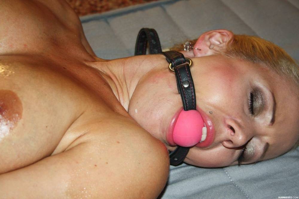Gagged babe with an oiled up body gets tied up for a BDSM sex action - #14