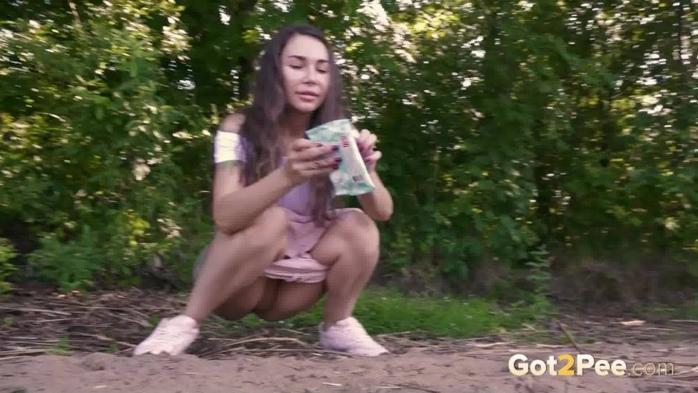 Brunette girl Sasha S emerges from the woods to take a piss on a patch of dirt - #4