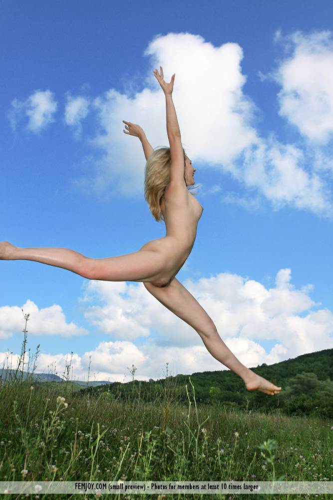 Thin blonde Thea C shows off her flexibility while posing naked in a field - #9