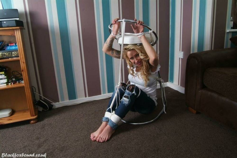 Fully clothed blonde Katie C struggles while restrained with rope bindings - #7