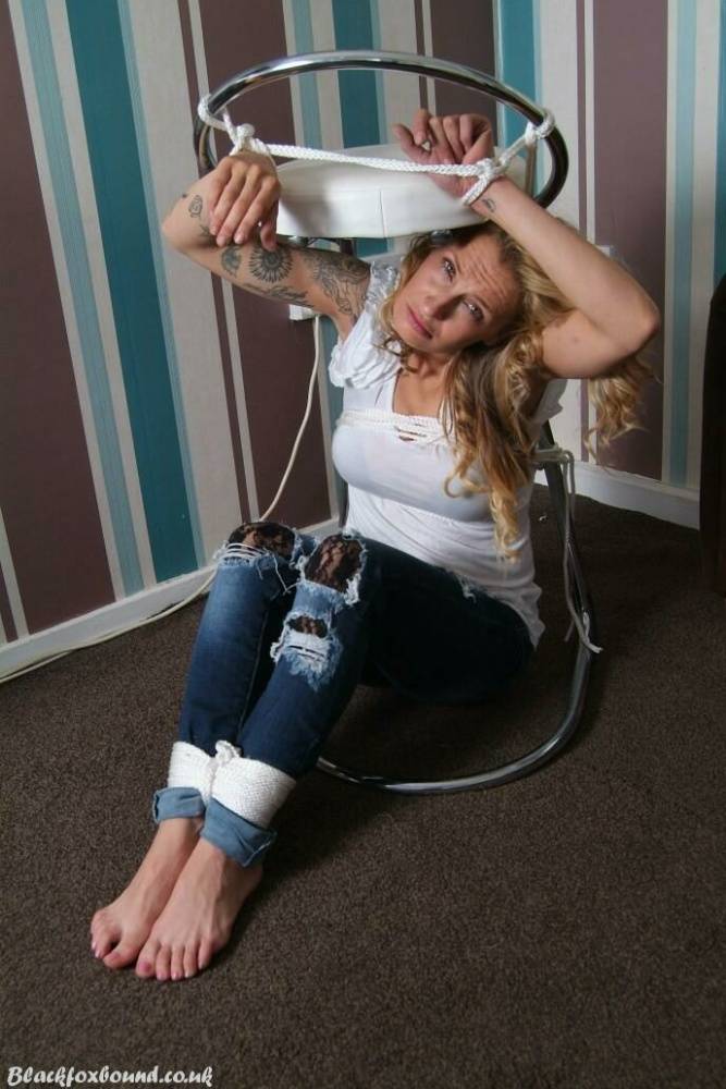Fully clothed blonde Katie C struggles while restrained with rope bindings - #6