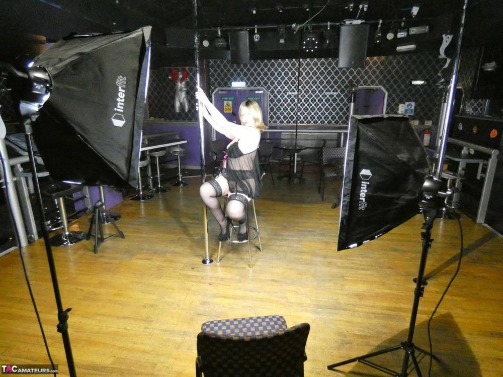 Older amateur Posh Sophia works a stripper pole inside an empty club - #1