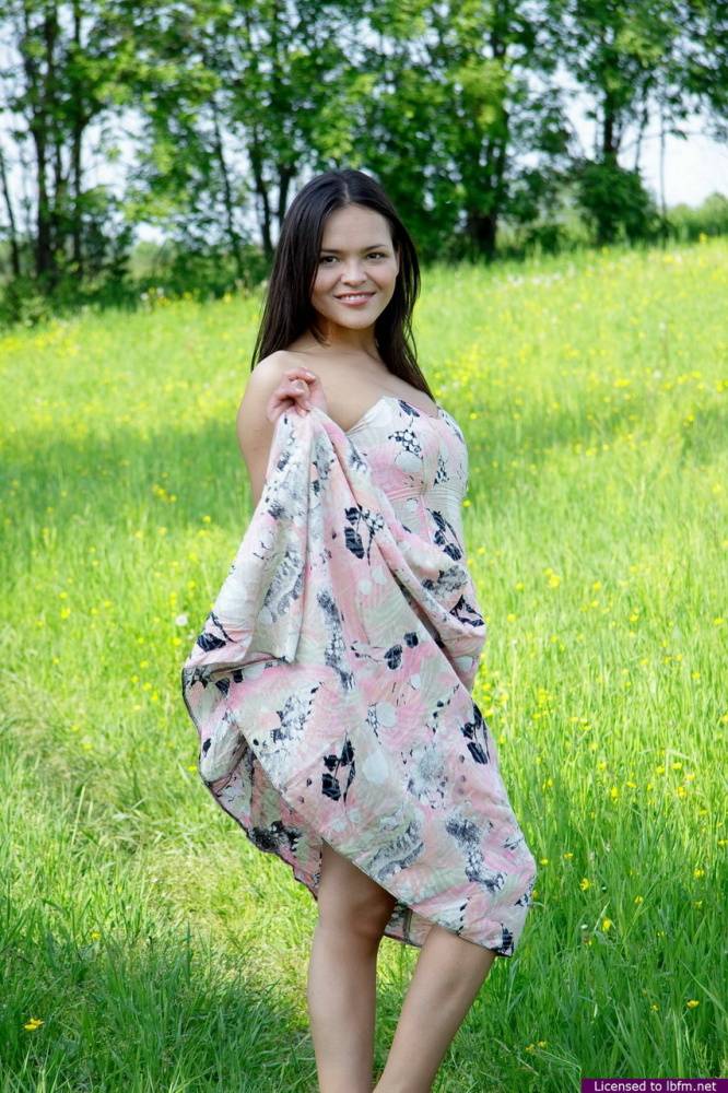 Nice Asian teen frees her breasts and pussy from her dress in a grassy meadow - #10