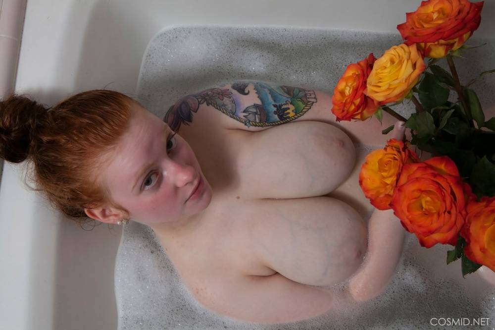 Pale redhead Kaycee Barnes displays her large boobs and butt during a bath - #1