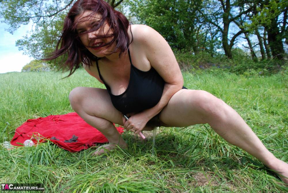British amateur Juicey Janey dildos her bush on a red blanket in a field - #14