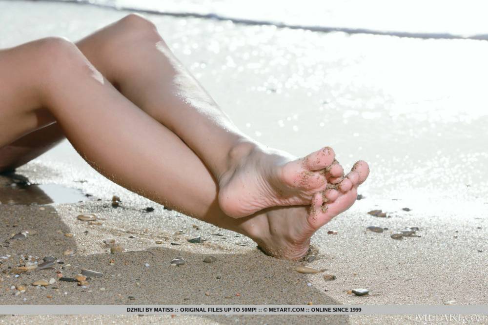 Beautiful Dzhili is out and about on a secluded beach when she starts to strip | Photo: 1011898