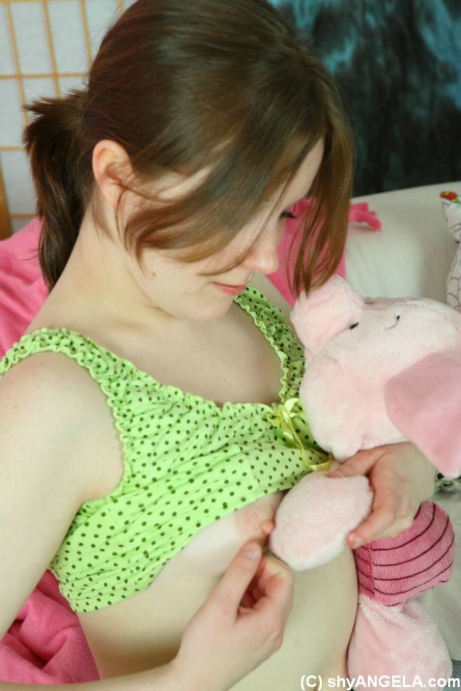 Sweet young girl Angela uncovers her tiny tits while playing with a plush toy - #13