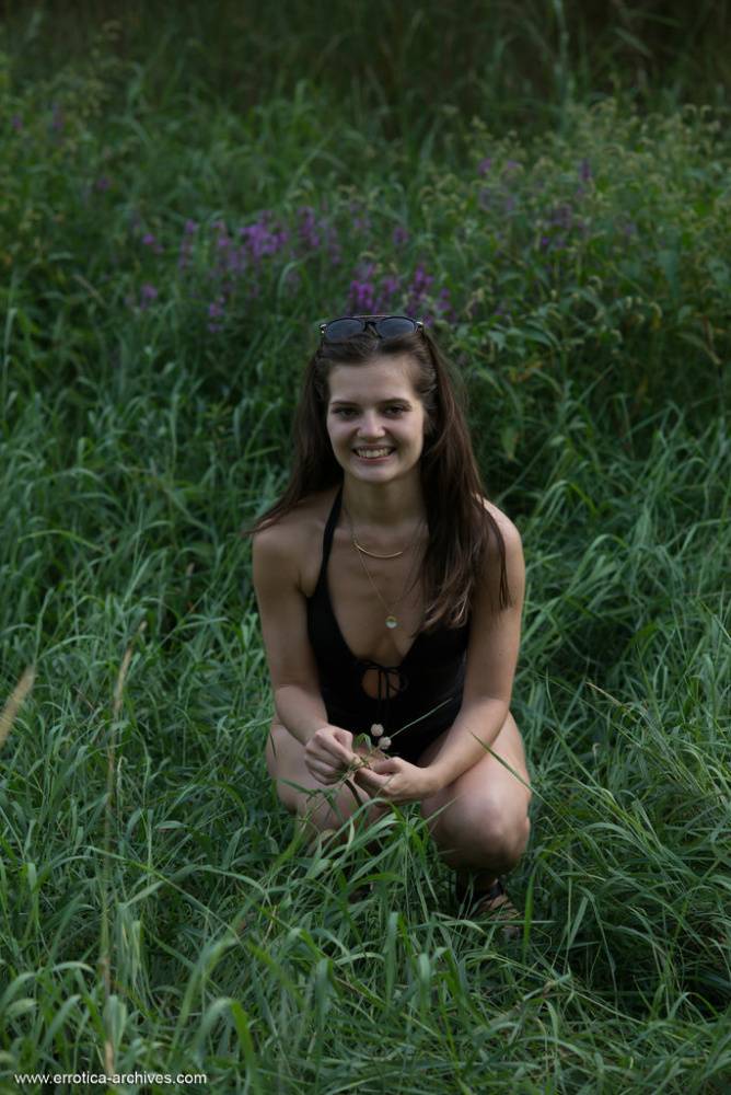 Petite young girl Pola gets naked in footwear on a bank while out in nature - #4