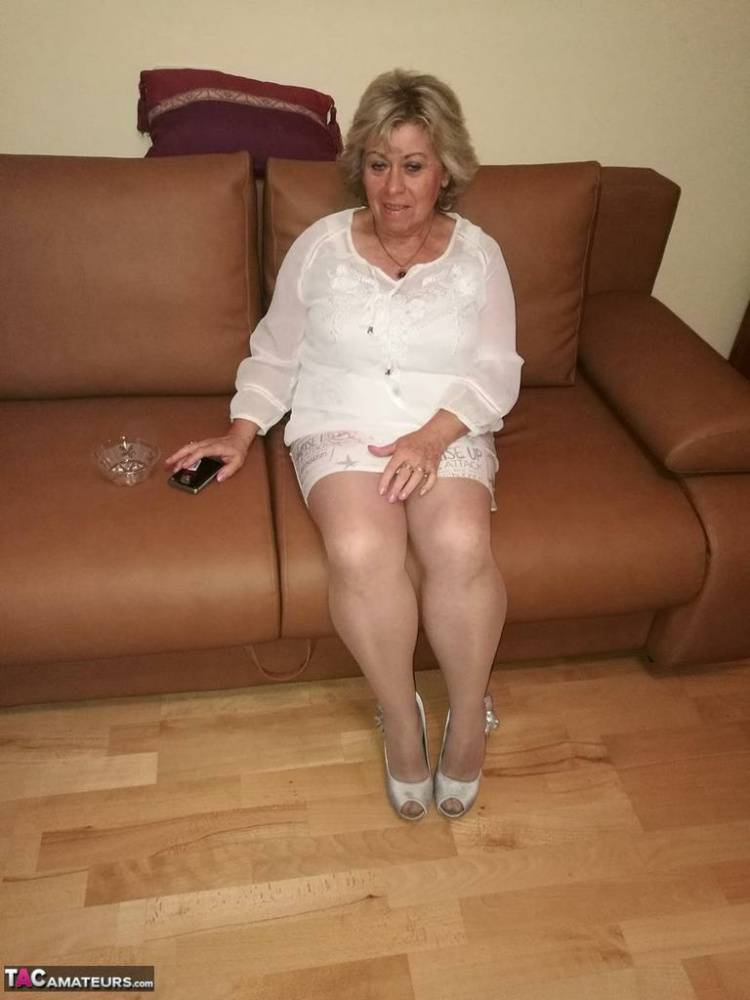 Mature lady exposes her large tits while having a smoke in pantyhose - #12