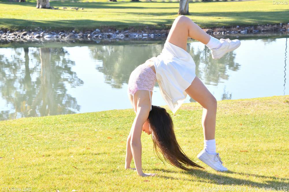 Brunette amateur Dakota does a cartwheel in a park before getting naked - #12