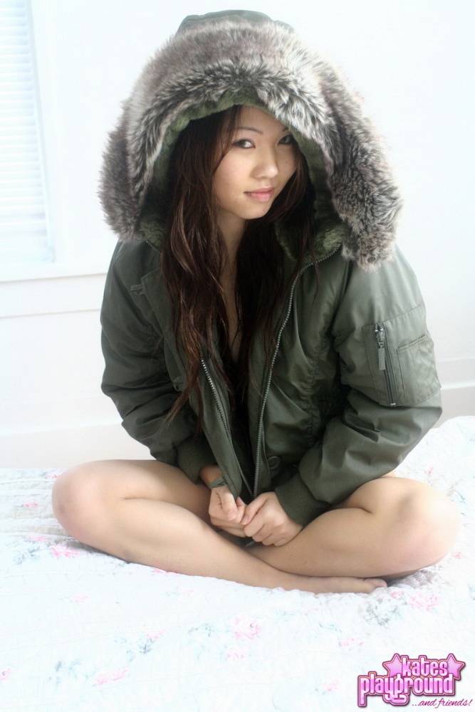 Asian amateur Grace removes a winter coat to model a thong during SFW action - #12