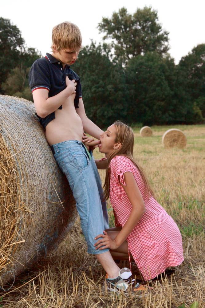 Young lovers Kitty Jane & Augustin have sex in a field against a round bale | Photo: 1038796