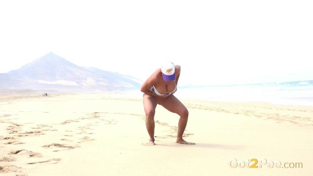 Caucasian female Chloe takes a piss while while traipsing on a deserted beach - #9