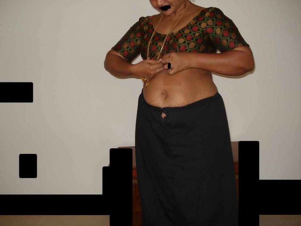 Overweight Indian housewife sports a braided ponytail while getting naked | Photo: 758001