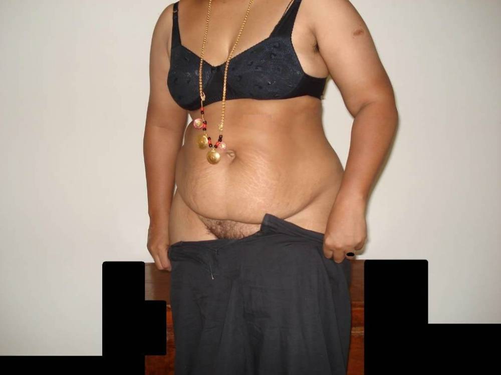 Overweight Indian housewife sports a braided ponytail while getting naked | Photo: 757990