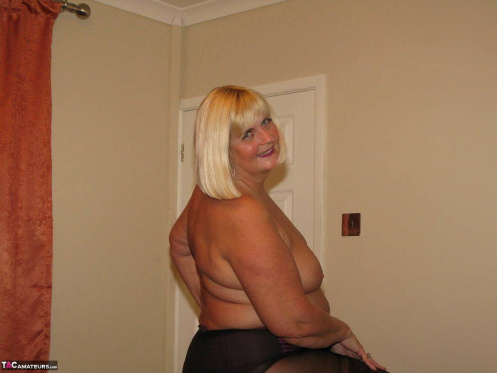 Mature blonde BBW Chrissy Uk goes topless before ripping open her pantyhose - #5