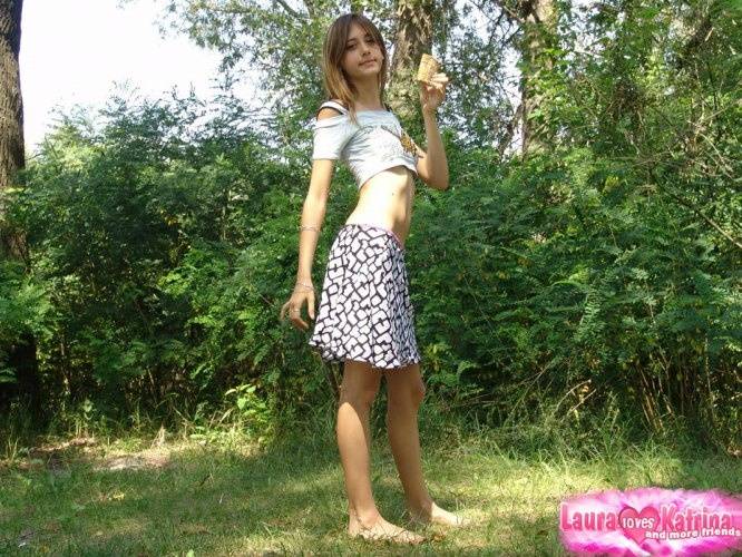 Shapely young teen in tiny t-shirt and short skirt posing outdoors - #4