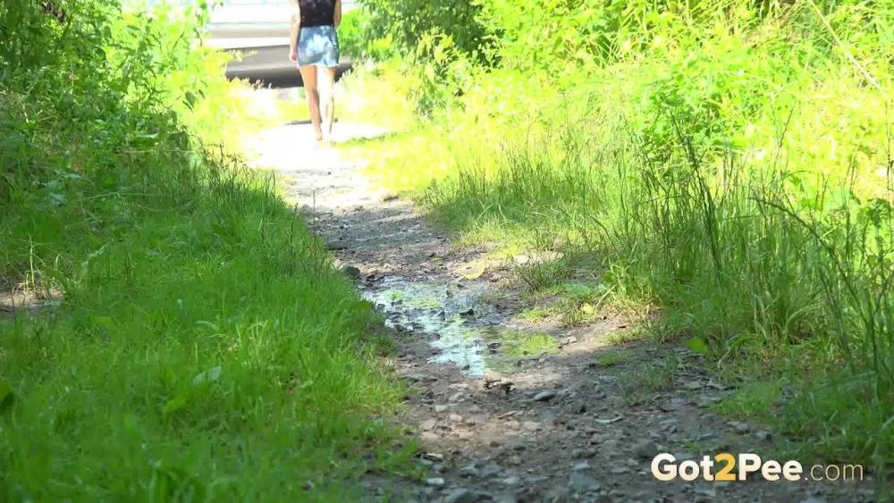 European female Nikki Dream takes a piss while walking on a dirt path - #6