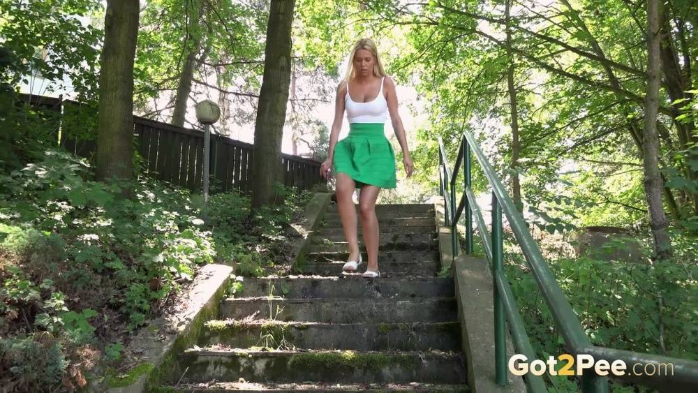 Blonde Nikki Dream in short skirt spreading legs and pissing in the forest - #1