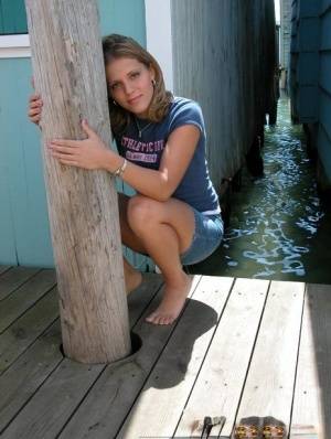Blonde solo girl flashes upskirt panties on lakeside boardwalk on realgirlsweb.com