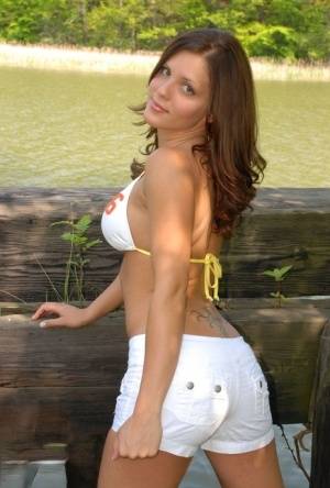 Teen amateur Karen undoes her bikini top with her shorts pulled down on realgirlsweb.com