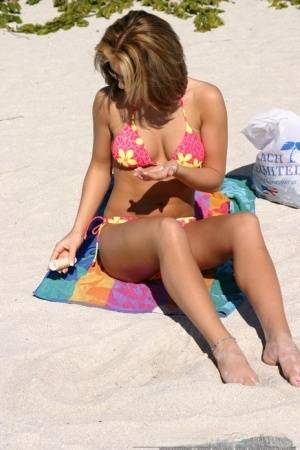 Teen solo girl Karen relaxes at the beach in a bikini and sunglasses on realgirlsweb.com
