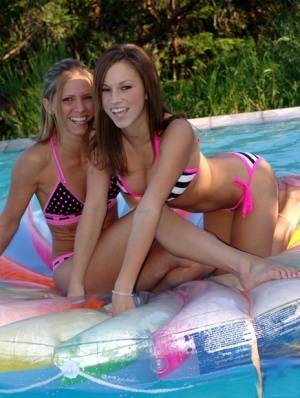Lesbian girls Karen and Kate fondle each other while wearing bikinis in a pool on realgirlsweb.com