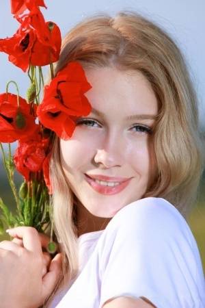 Sweet teen Genevieve Gandi strips naked in a field of blooming flowers on realgirlsweb.com