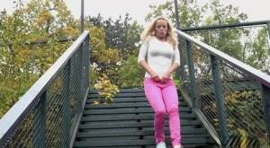 Blonde Victoria Pure pulling down her tight pants to pee on the bleachers on realgirlsweb.com