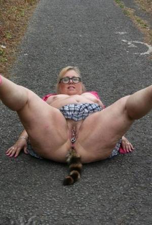 Fat UKwoman Lexie Cummings walks a path sporting a raccoon tail butt plug on realgirlsweb.com