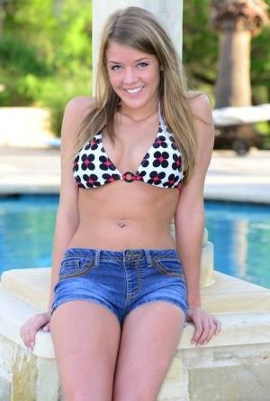 Cute teen Sophia Wood drops her shorts by the pool to toy with a vibrator on realgirlsweb.com