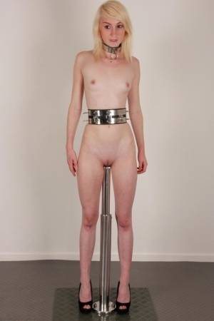 Skinny blonde teen Noa sports a collar while impaled on a dildo post on realgirlsweb.com