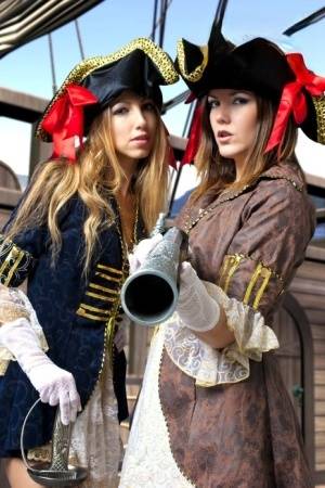 Female pirates partake in lesbian foreplay while on board a vessel on realgirlsweb.com