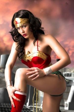 Beautiful brunette peels off her Wonder Woman outfit in a tempting manner on realgirlsweb.com