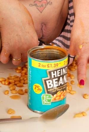 Mature amateur Dirty Doctor covers her naked body in a can of beans and sauce on realgirlsweb.com