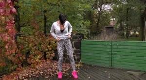 Short haired female Gabriellla Gucci squats for a pee on a deck on realgirlsweb.com