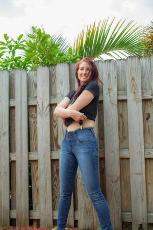 Hot redhead Andy Adams loses her t-shirt & jeans in the yard to pose naked on realgirlsweb.com
